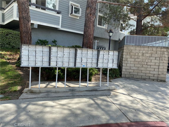 Front view of a building with mailboxes outside.