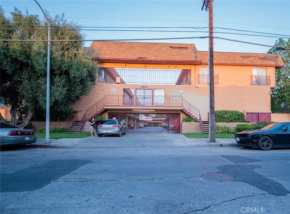 Front view of a multi-story building with a parking area.