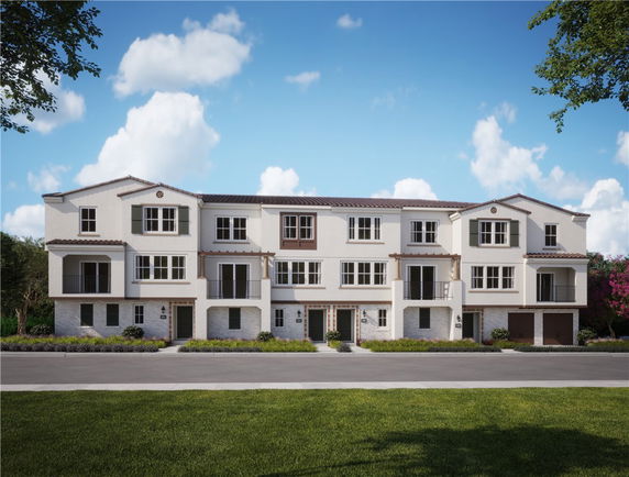 Front view of a multi-story residential building with balconies.