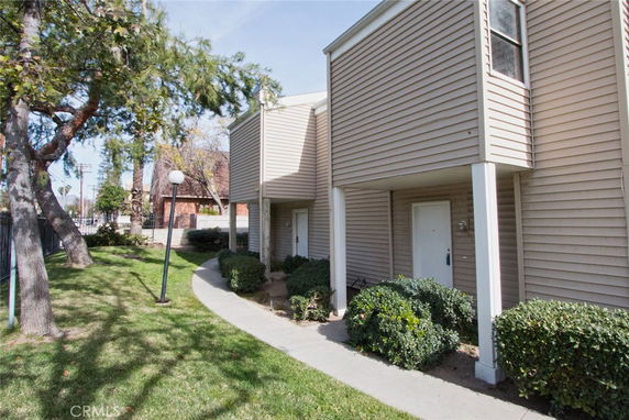 Front view of a residential building with multiple entry doors.