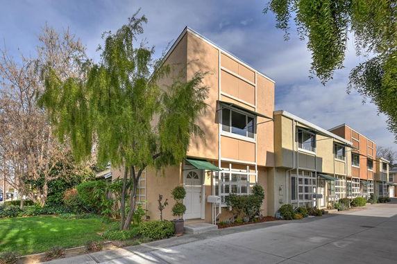 Front view of a modern townhouse complex with multiple units and large windows.