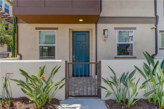 Front view of a house with a gated entrance and blue door