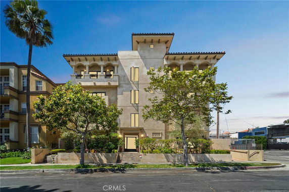 Front view of a multi-story building with balconies and a modern design.