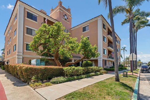 Front view of a multi-story residential building with balconies.