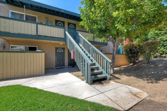 Front view of a two-story building with stair access to upper level.