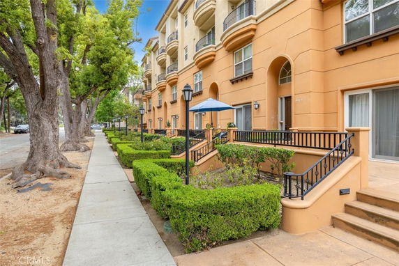 Front view of multi-story residential building with balconies.