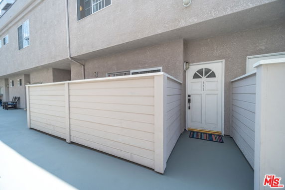 Front view of a building with an enclosed entrance patio.