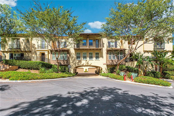 Front view of a two-story residential building with multiple balconies.