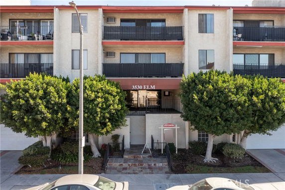 Front view of a multi-story apartment building with balconies.