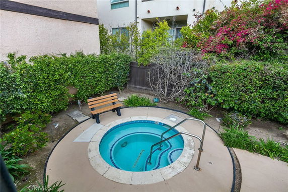 Small round outdoor pool with surrounding greenery.