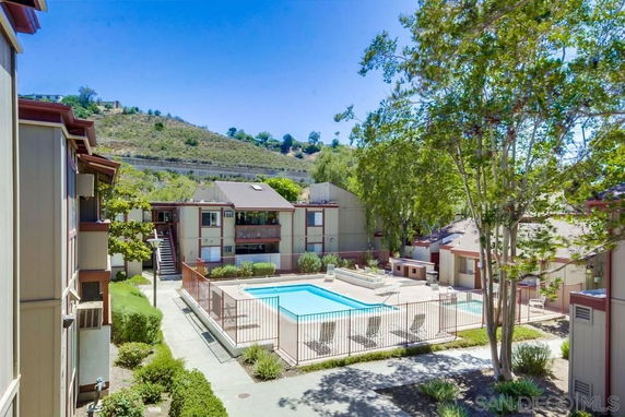 Outdoor view of residential complex with central swimming pool.