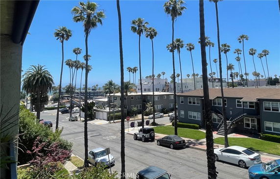 View of surrounding areas with palm trees and buildings near the coastline.