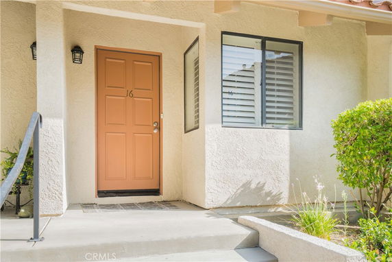 Front view of a house entrance with a single door and window.