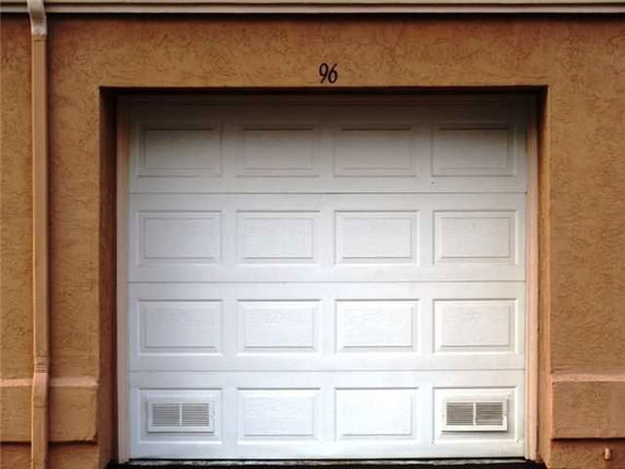 Front view of a single garage door with the number 96 above it.