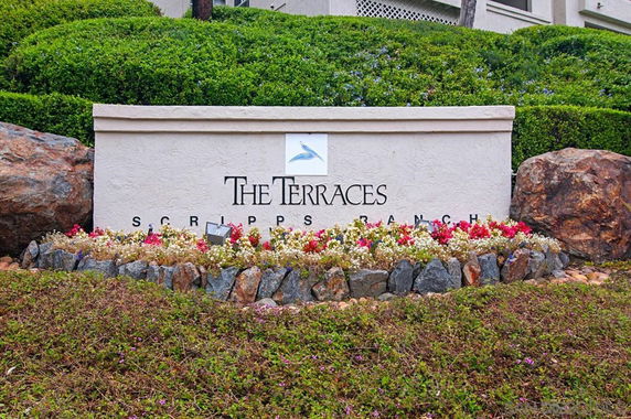 Signage for The Terraces at Scripps Ranch surrounded by landscaping.