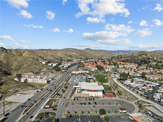 Panoramic view of a residential area with surrounding hills and roads.
