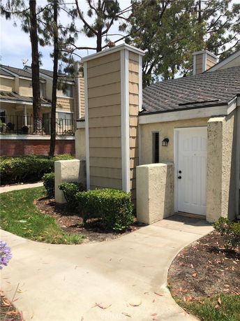 Front view of a house with a pathway leading to the entrance.