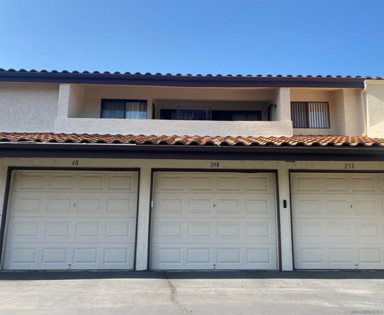 Front view of a two-story building with three garage doors.