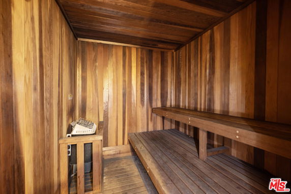 Interior view of a wooden sauna room with benches.