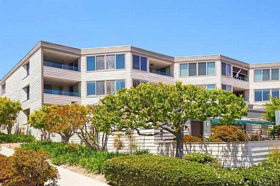 Front view of a multi-story residential building with balconies.