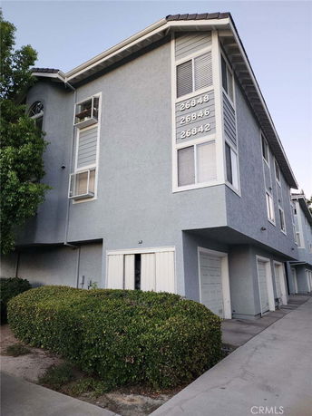 Front view of a multi-story building with garages.
