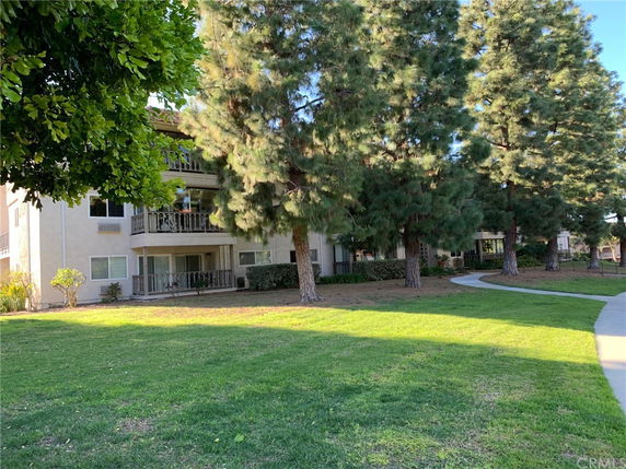 Front view of a multi-story residential building with balconies.