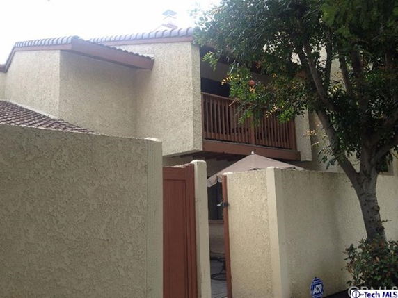 Front view of a two-story house with a balcony.