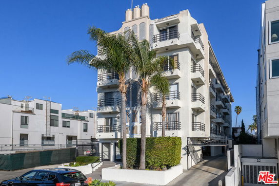 Front view of a multi-story residential building with balconies.