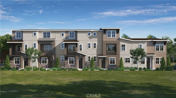 Front view of a modern multi-story residential building with balconies and a landscaped front lawn.