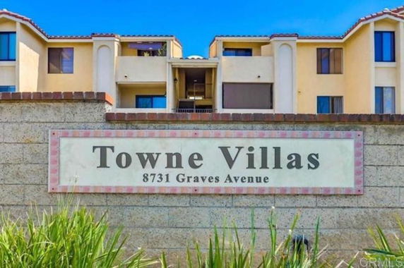 Front view of a multi-story building with a sign reading Towne Villas.