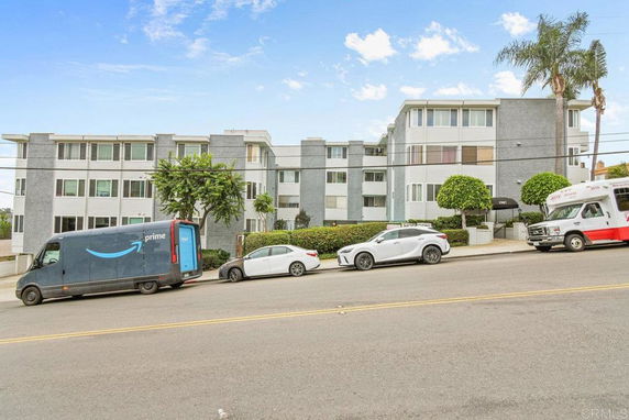 Front view of a multi-story apartment building with a modern design.
