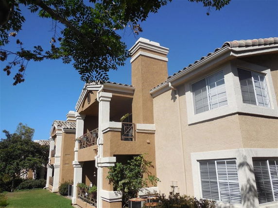 Front view of a multi-story apartment building with balconies.