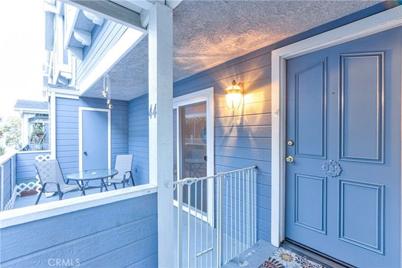 Front view of a house with a blue exterior and a small porch area.