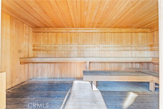 Interior view of a wooden sauna with benches.