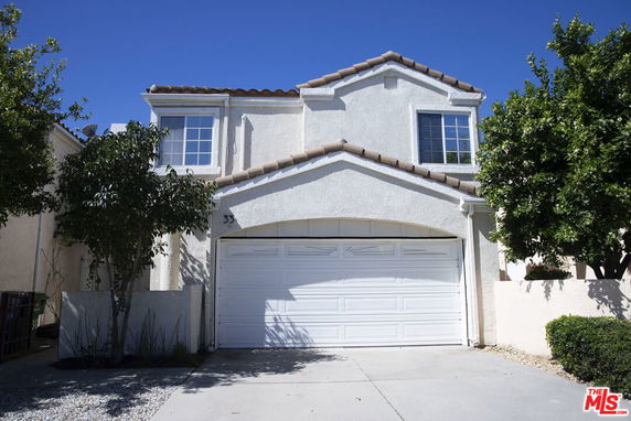 Front view of a two-story house with a double garage.