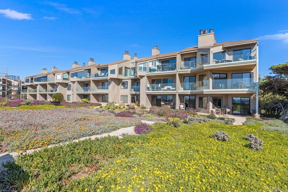 Front view of a multi-story residential building with balconies.