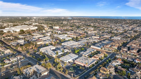 Wide aerial view of an urban area with buildings and roads.