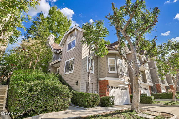 Front view of a multi-story house with a garage.