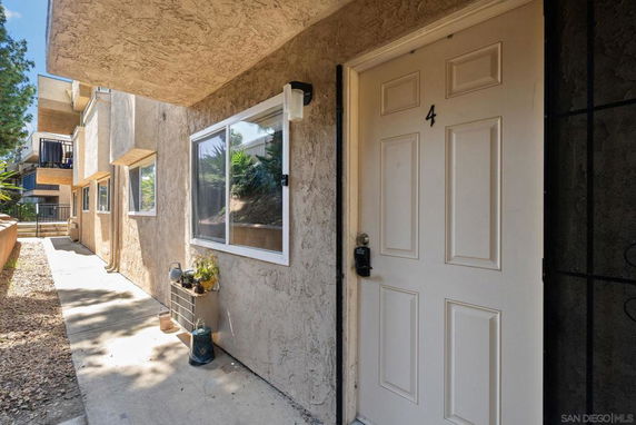 Front view of a building with a numbered door and windows.