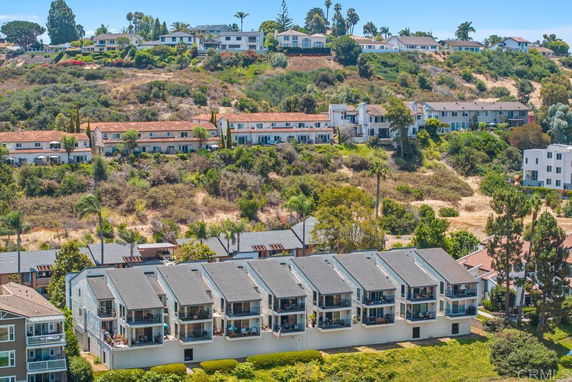 Panoramic view of multiple residential buildings on a hillside.