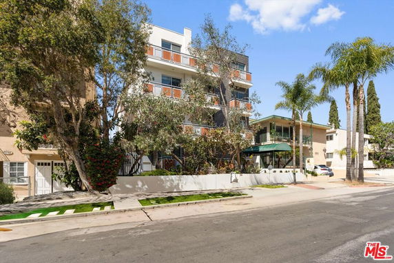 Front view of a multi-story residential building with balconies.