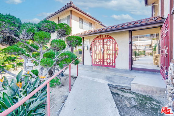 Front view of a house with traditional architectural elements and decorative entrance.