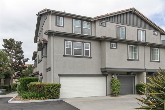Front view of a multi-story house with a double garage.