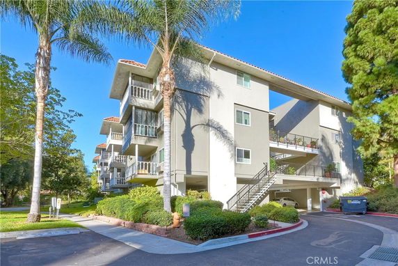 Front view of a multi-story residential building with balconies.