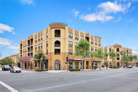 Front view of a multi-story building with retail spaces on the ground floor.