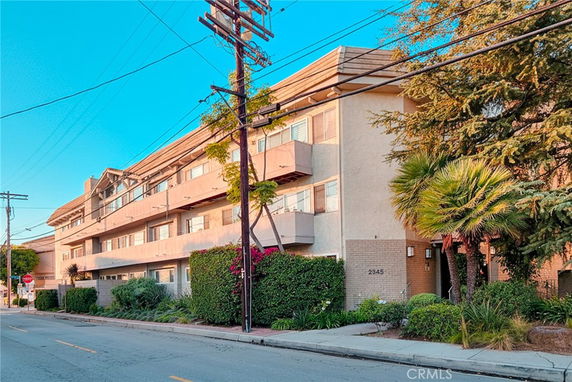 Front view of a multi-story apartment building with balconies.