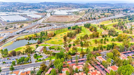 Wide-angle view of a landscape with roads, buildings, and greenery