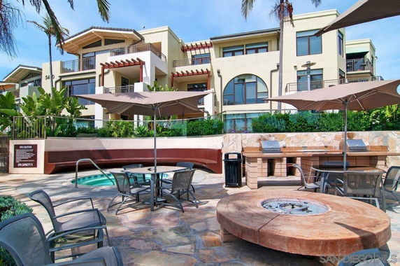 Outdoor view of a modern residential building with balconies and large windows.