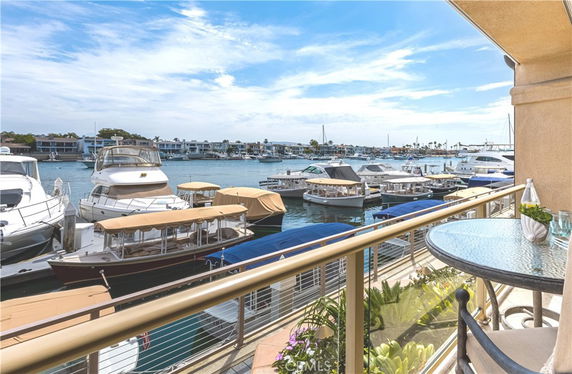 Panoramic view of a marina with docked boats seen from a balcony.