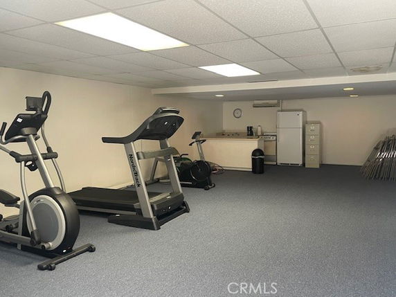 Indoor gym area with exercise equipment and a small kitchenette.